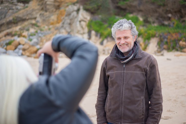 Photo Of A Person Taking A Picture Of An Elderly Man