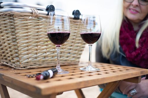 Free Elegant red wine glasses on a wooden table during an outdoor picnic, Portugal. Stock Photo