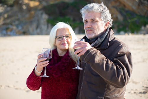 Couple with Wine Glasses on Beach