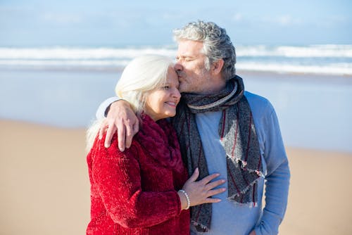 Free An Elderly Man Kissing an Elderly Woman on the Forehead Stock Photo