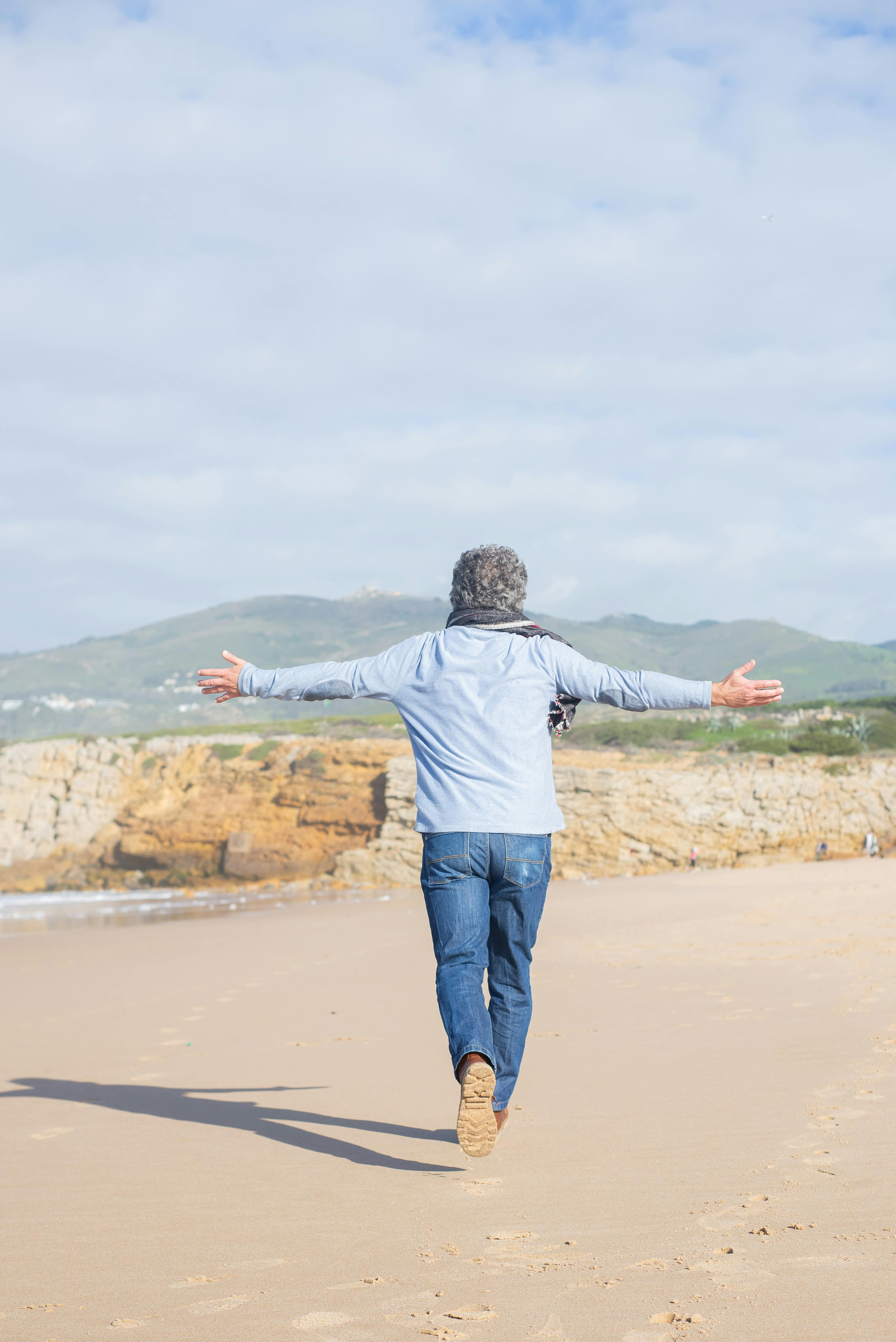 man walking on white sand