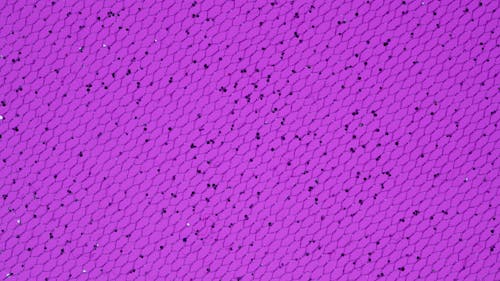 Photo of a Purple Surface with Black Spots