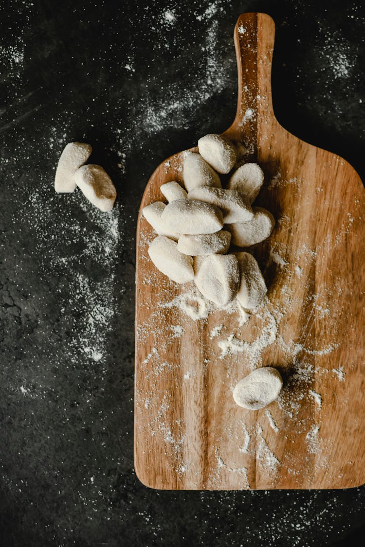 Doughs Sprinkled With Crumbs On A Wooden Chopping Board