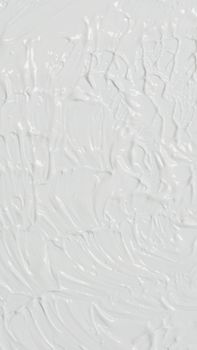 Close-up of abstract white acrylic paint texture with a rough, subtle finish. Ideal for modern art backgrounds.