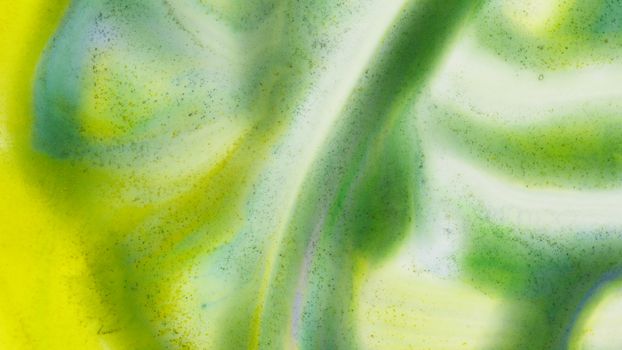 Dynamic abstract artwork showcasing a vibrant blend of green and yellow hues, creating a fluid, artistic effect.