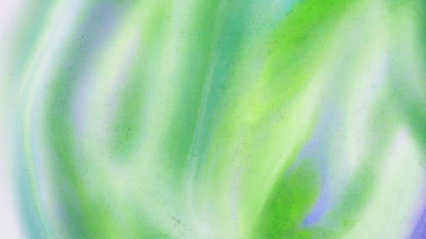 A colorful abstract watercolor painting with vibrant green and blue hues, evoking creativity and artistic expression.