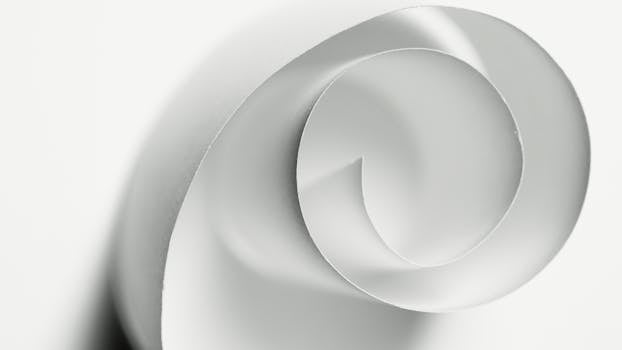 Minimalistic abstract design of a white paper spiral showcasing curves and shadows.