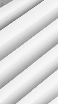Abstract monochrome vertical pattern featuring repetitive white shapes and textures.
