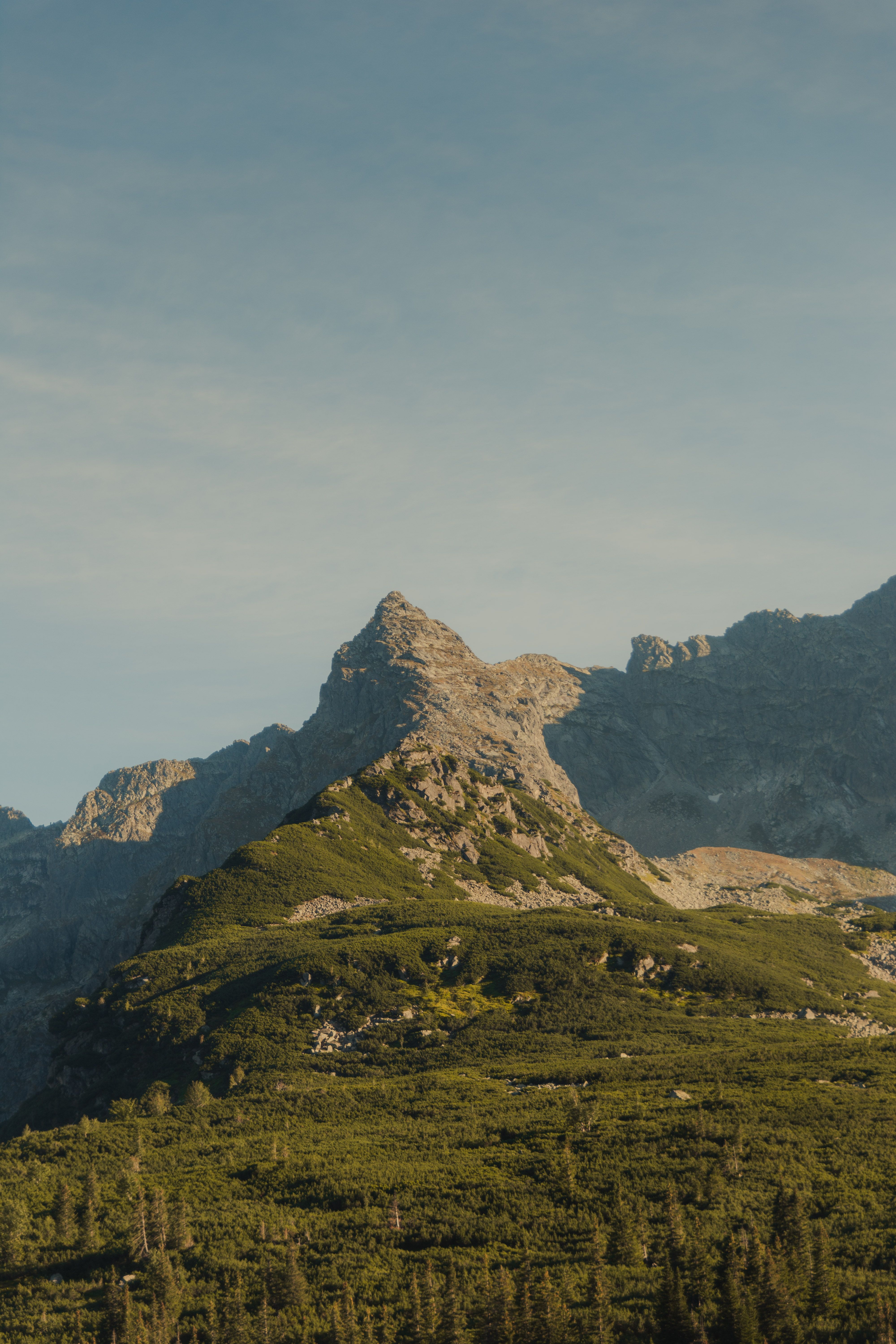 A serene view of a mountain peak captured during sunrise, showcasing nature's beauty.