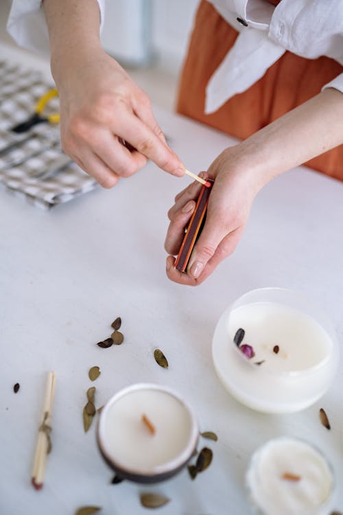 A Person Lighting a Match Stick