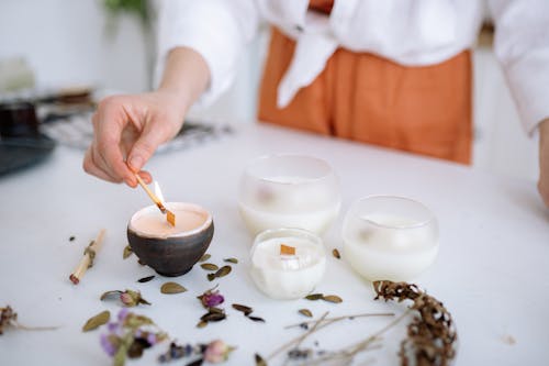 Free A Person Lighting a Candle with a Matchstick Stock Photo