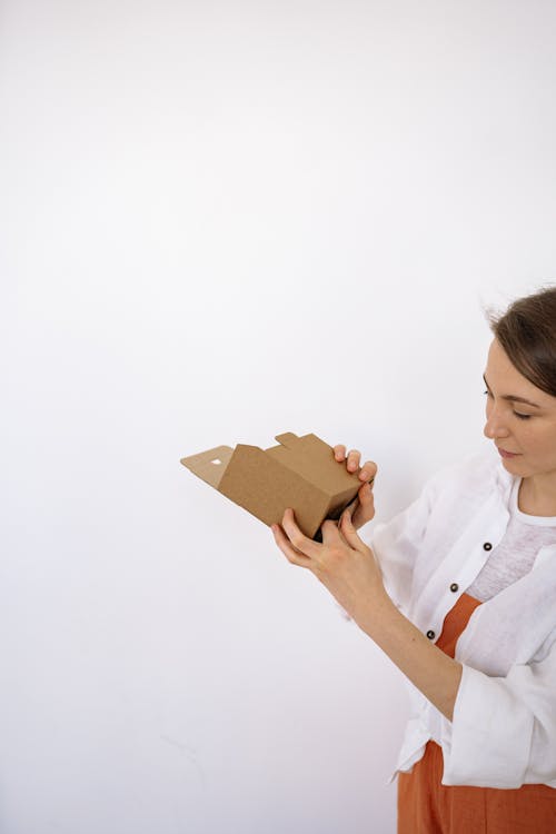 A Woman Folding a Box