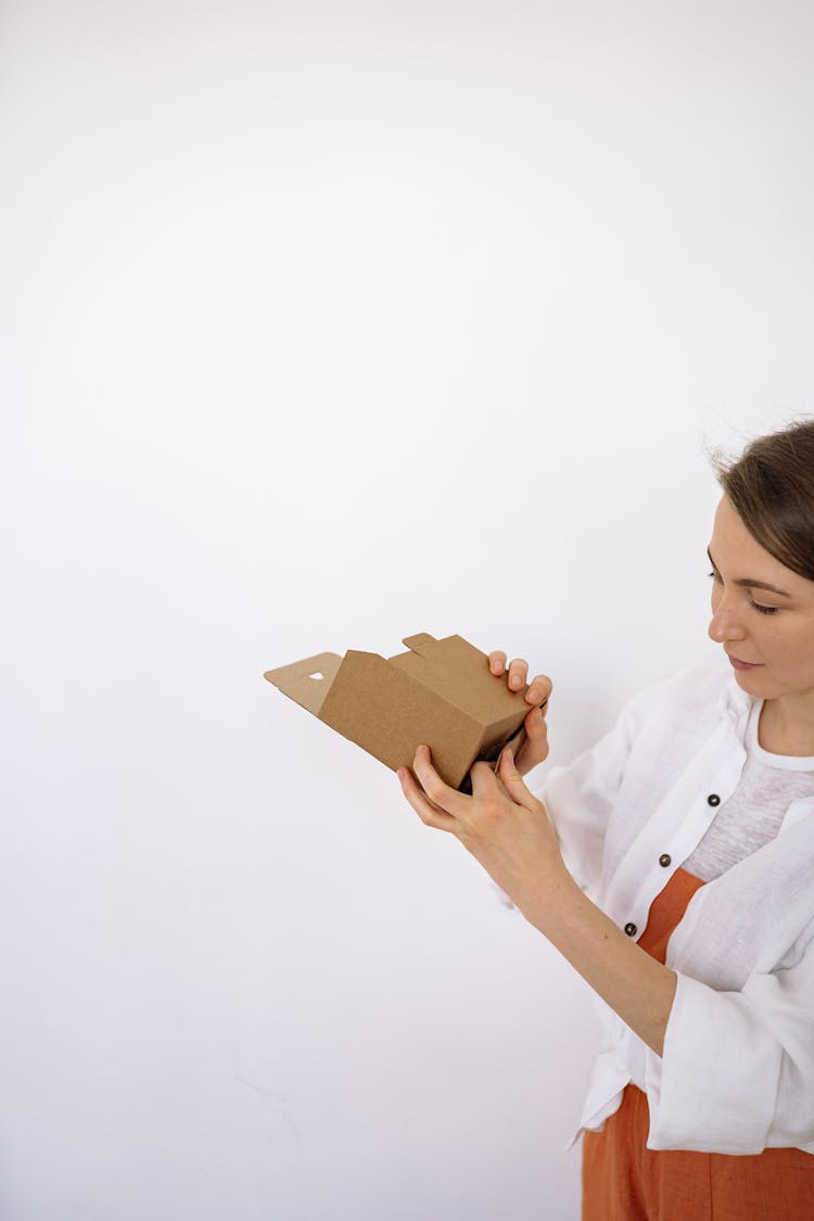 A Woman Folding A Box