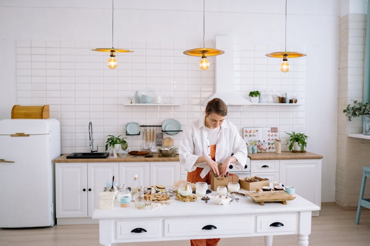 Woman Packing Candles Into Boxes