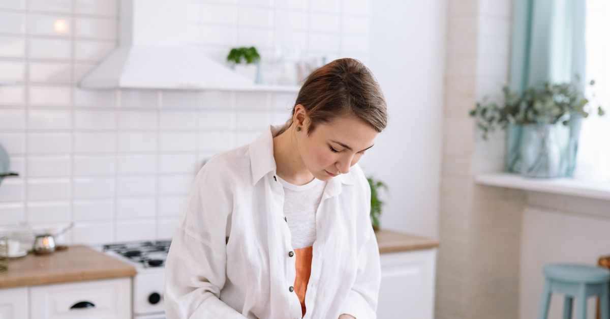 Woman pouring wax to hand-make a candle as part of a small candle business