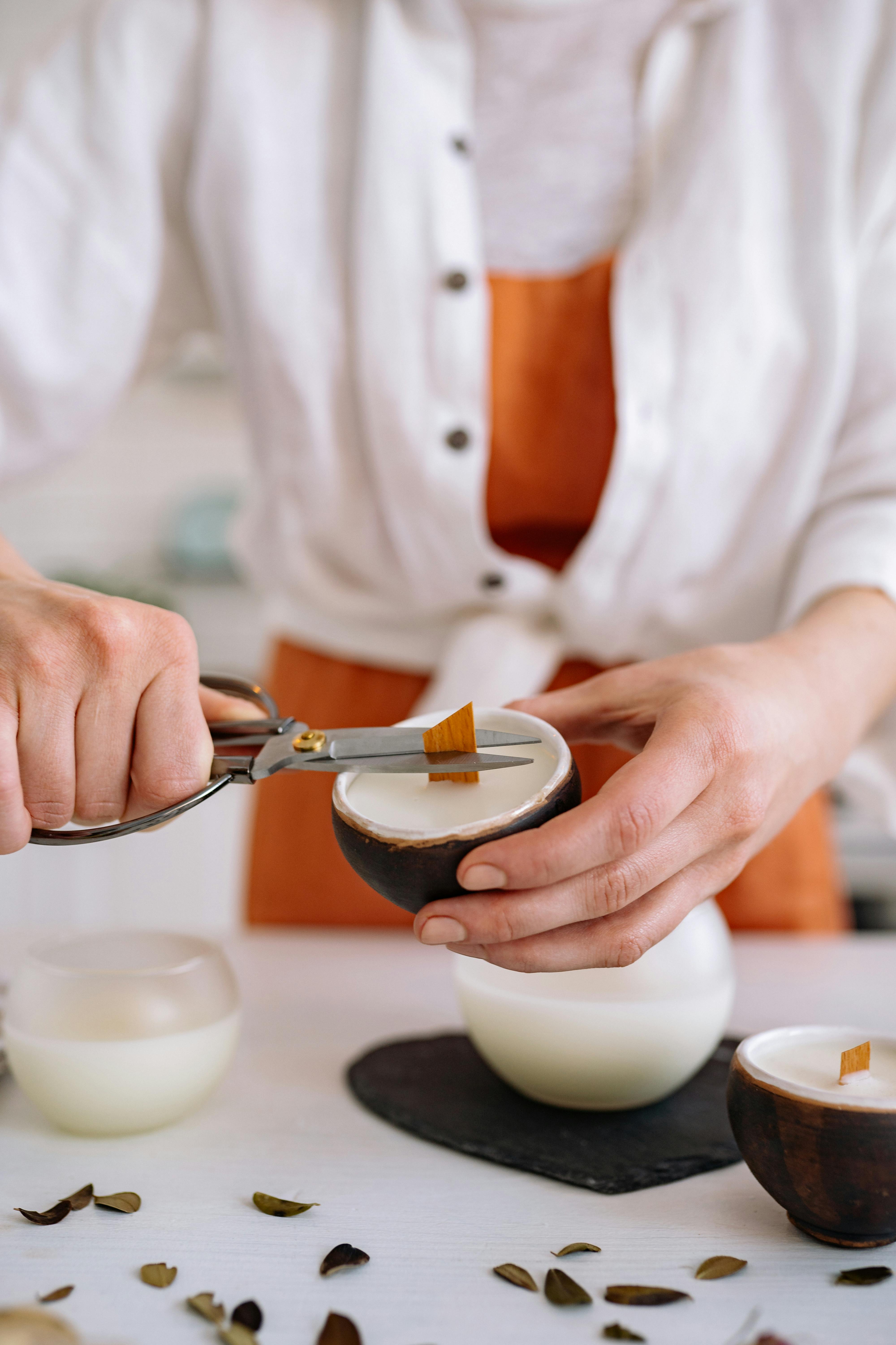 A Person Cutting the Candle Wick in a Candle · Free Stock Photo