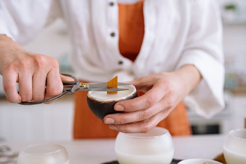 A Person Cutting a Candle Wick