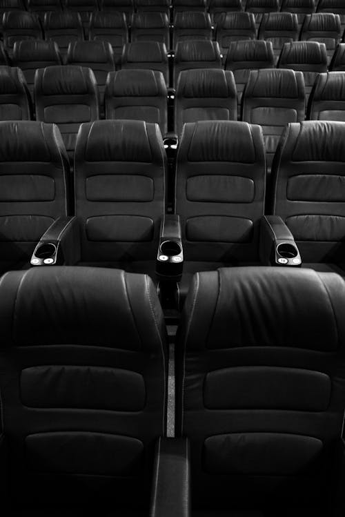 Grayscale Photo of Empty Seats in Movie Theater