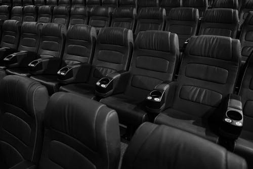 Grayscale Photo of Empty Seats in Movie Theater