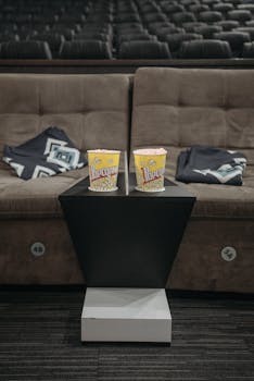 Luxurious cinema seating with popcorn, perfect for movie night in a cozy theater setting.