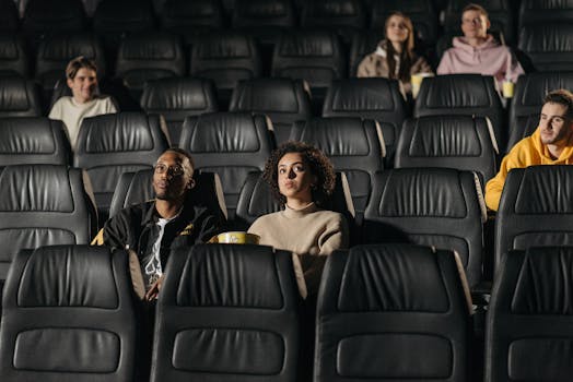 Cinematic audience sitting in comfortable seats, engrossed in a movie experience.