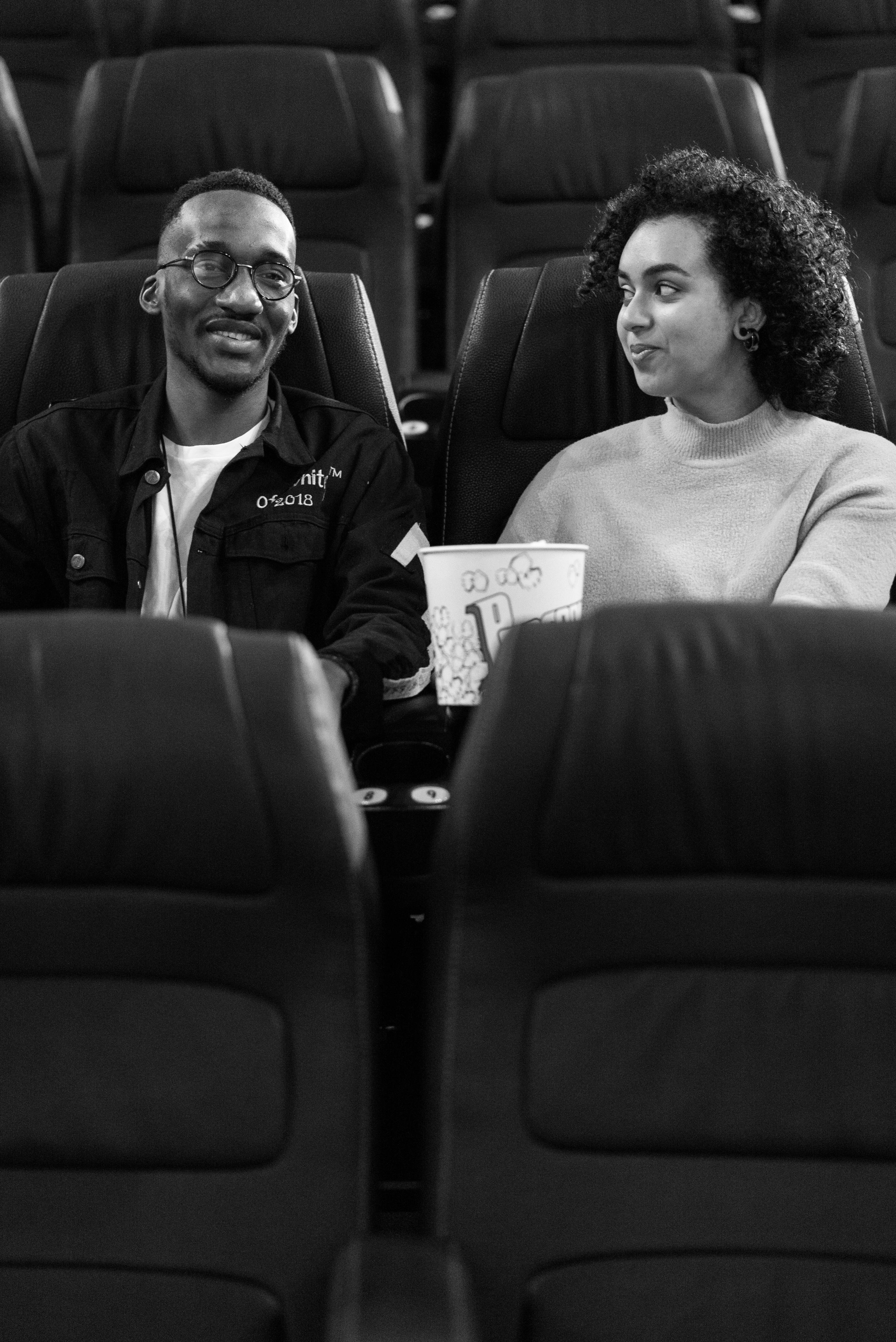 a couple sitting inside a movie theater