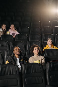 Group of friends enjoying a movie experience at a cinema theater.