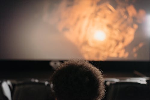Free A Person Watching a Movie in a Cinema Stock Photo