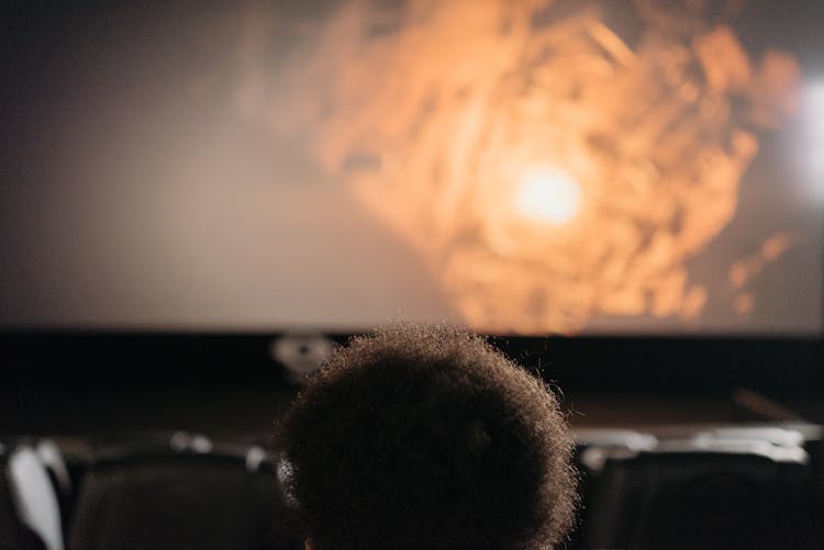 A Person Watching A Movie In A Cinema