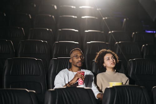 Photo of a Couple Watching a Movie in a Cinema