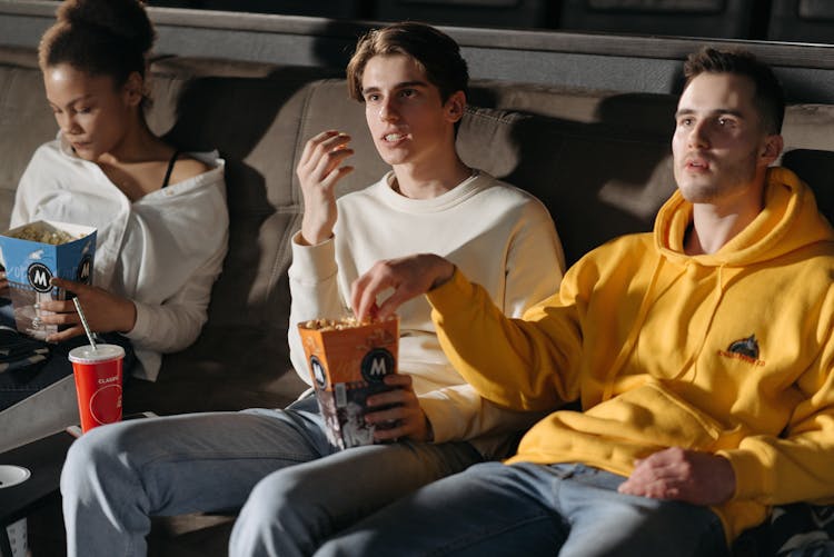 A People Eating Popcorn While Watching A Movie