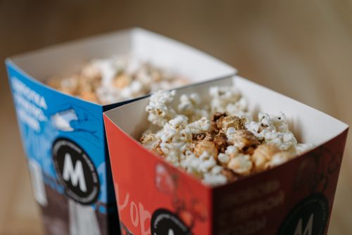 Free A close-up view of popcorn in red and blue boxes, perfect for movie nights. Stock Photo