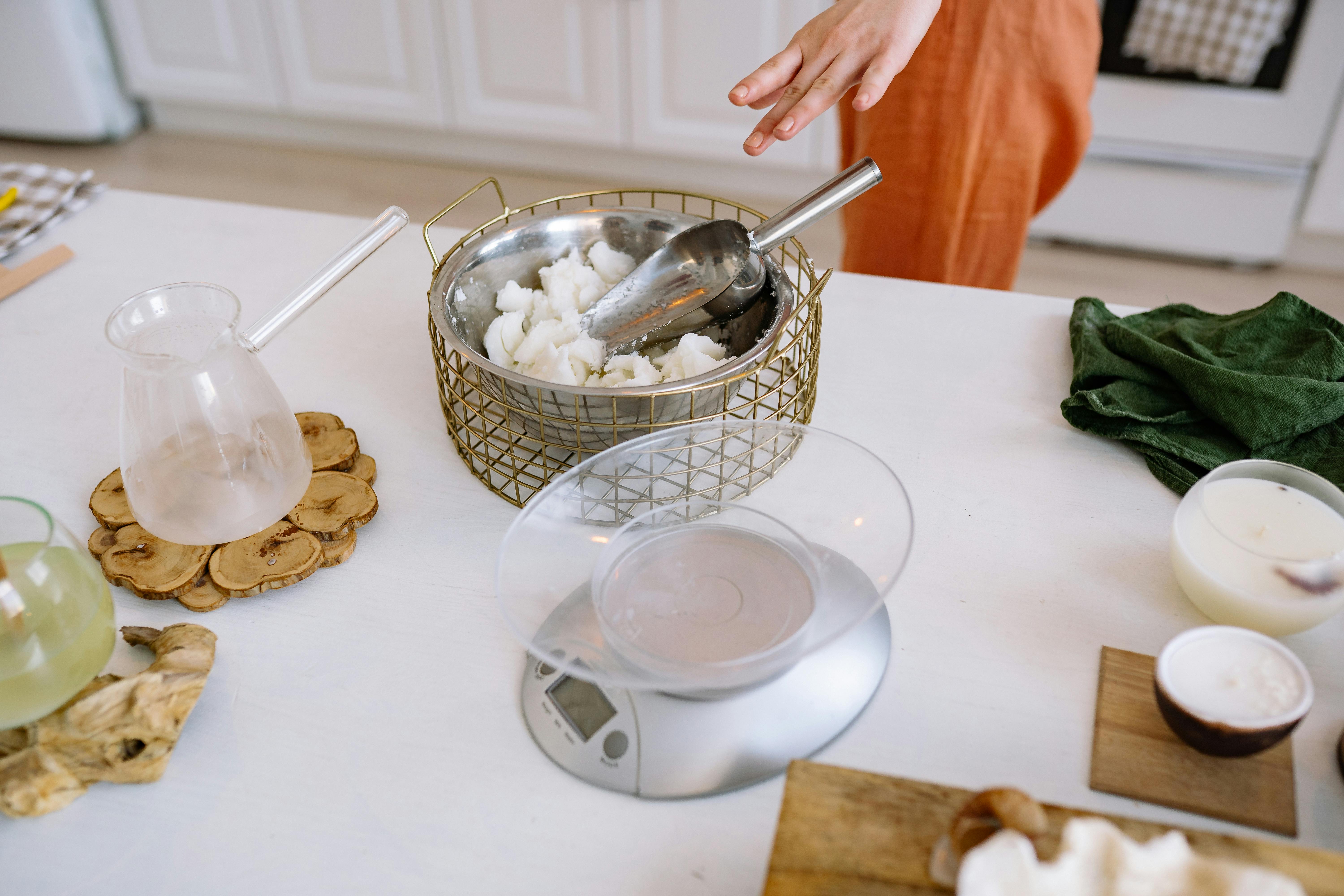 Free A person crafting handmade candles in a cozy kitchen with natural materials. Stock Photo