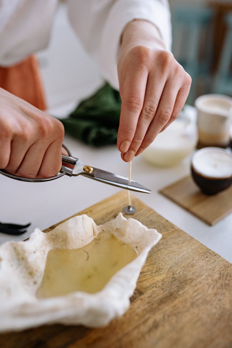 Person Cuts Cotton Wick