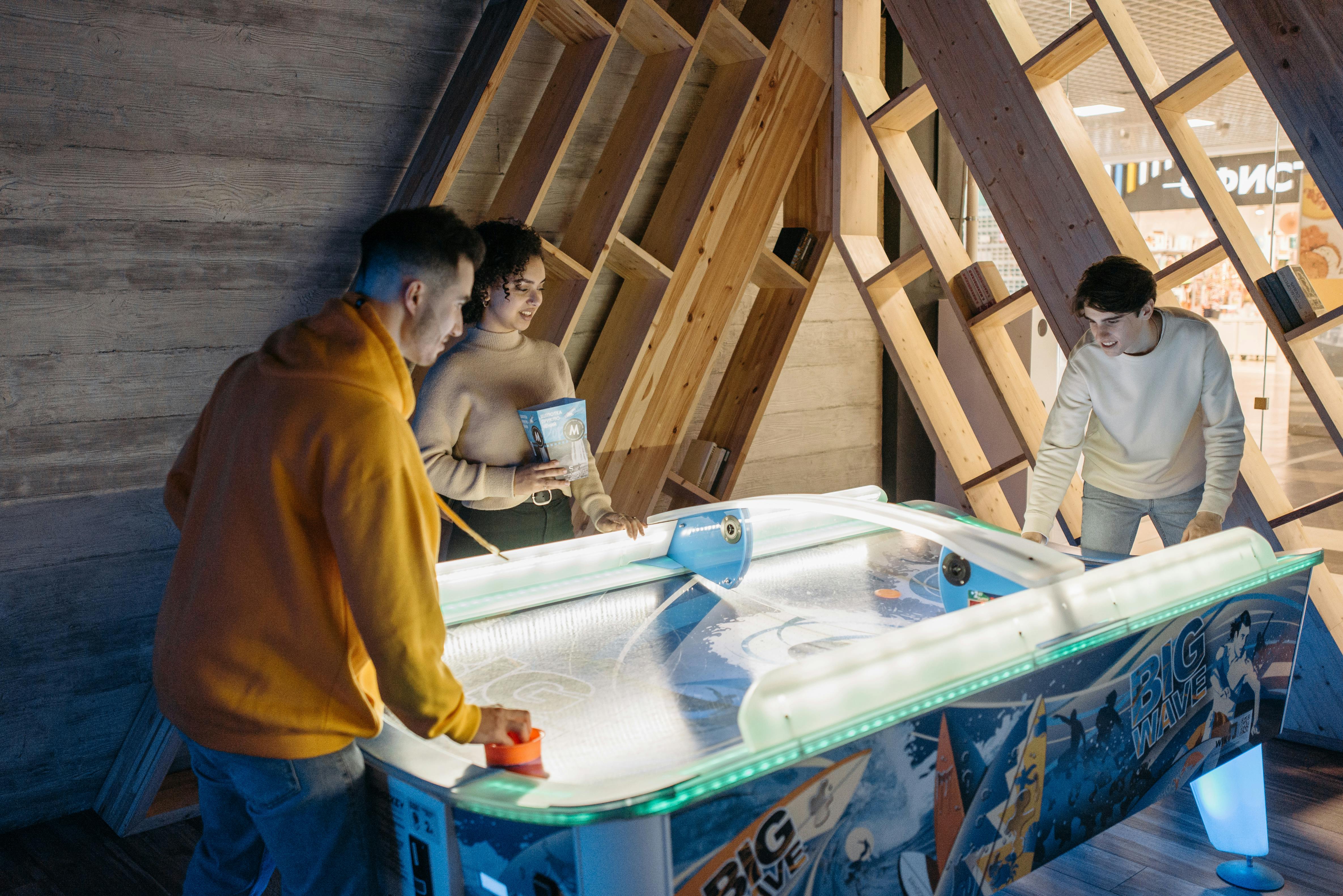 friends playing in table hockey