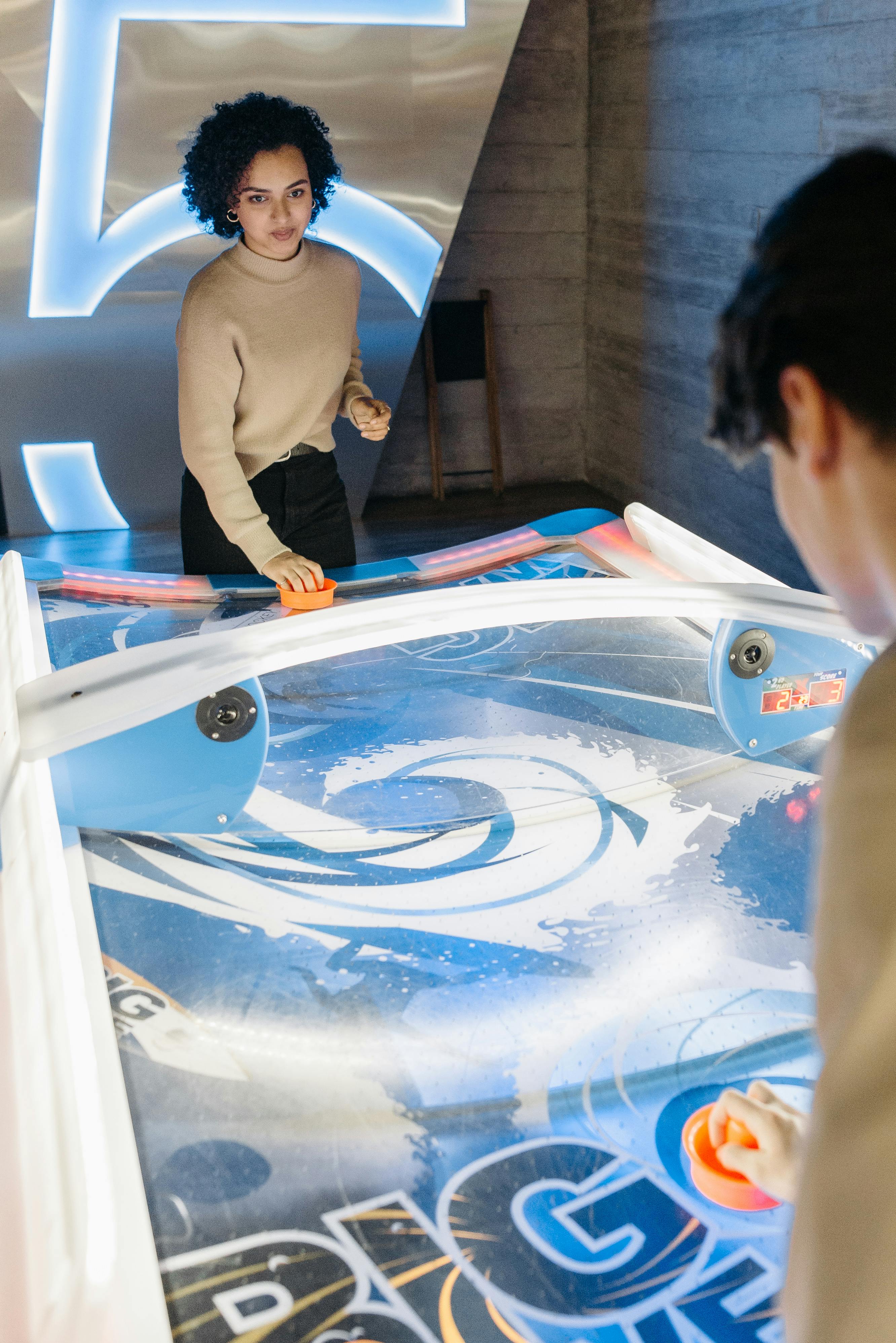 man and woman playing an arcade game