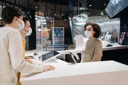 People at cinema counter wearing masks as part of new normal safety measures.