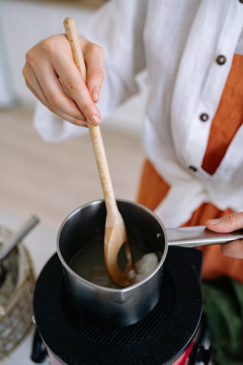 A Person Holding a Wooden Spoon