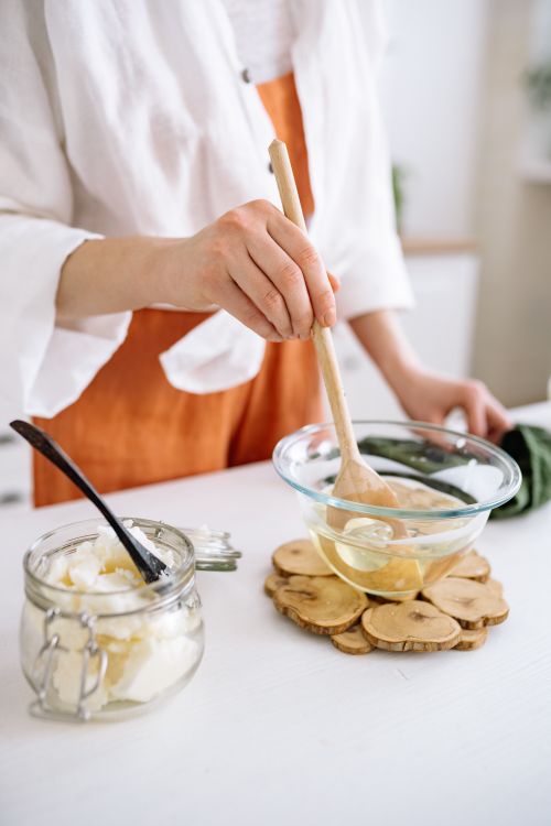 Free Woman making candles at home with natural wax and essential oils. Stock Photo
