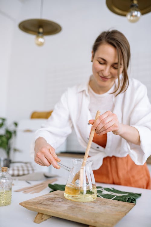 A Woman Mixing Melted Wax 