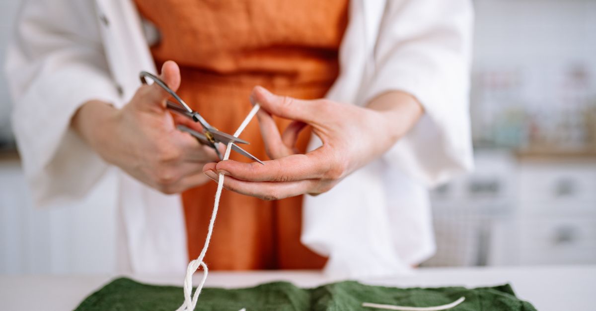 A Person Cutting a String · Free Stock Photo