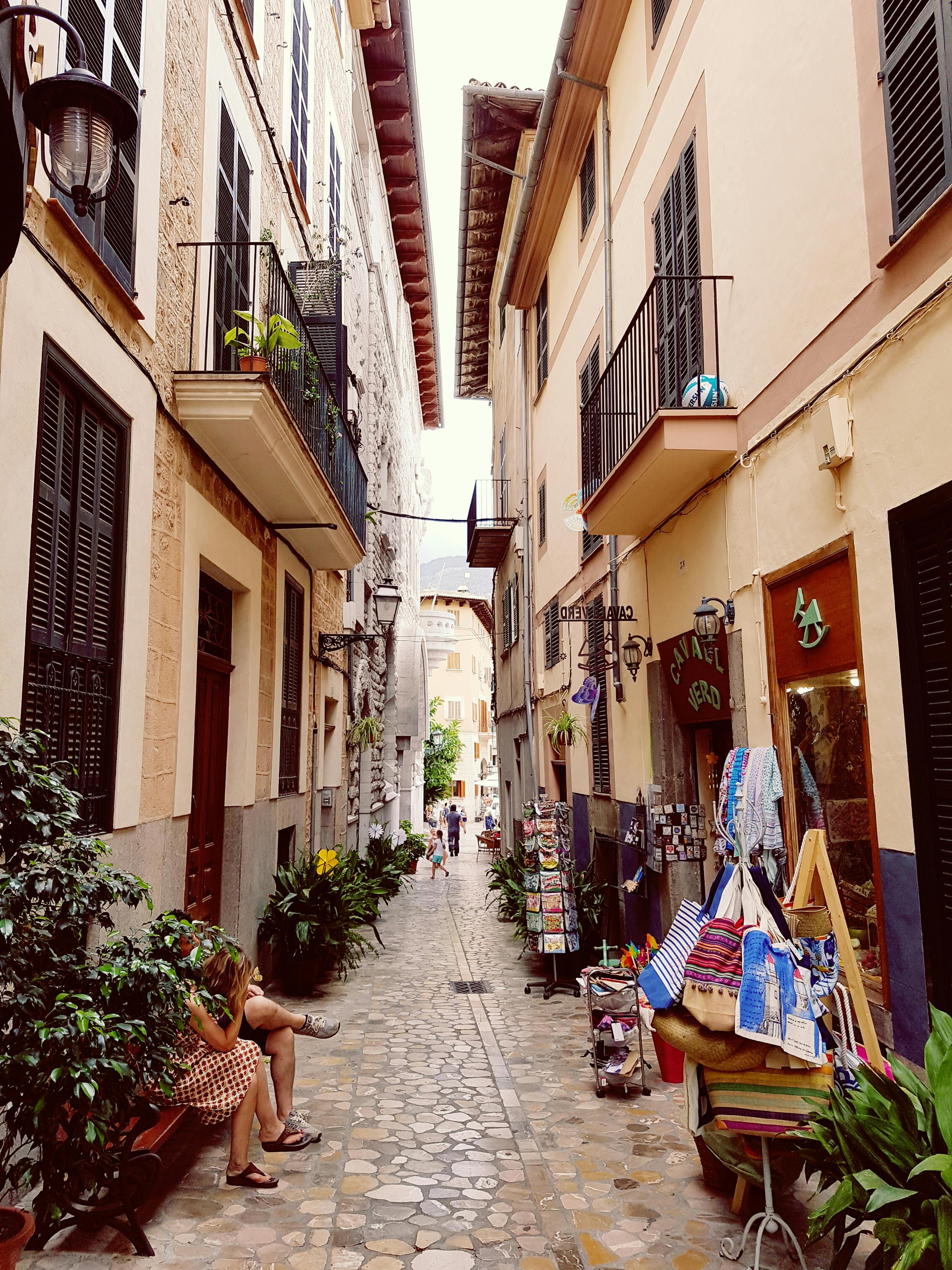 photo of concrete buildings with little stores in between buildings