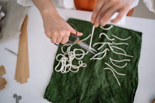 Overhead Shot of a Person Cutting Candle Wicks