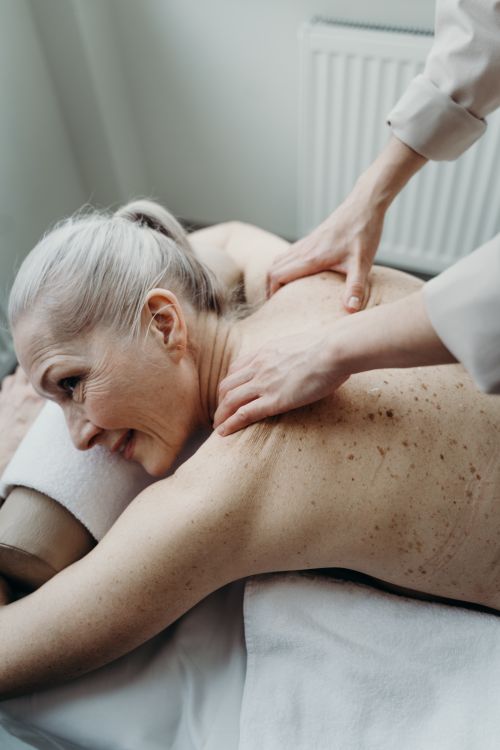 Free Elderly woman enjoying a soothing massage for relaxation and wellness. Stock Photo