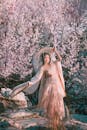 A Woman Wearing Hanfu Gown Standing Near Cherry Blossom Tree