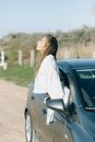 Photograph of a Woman Getting Out of a Car Window