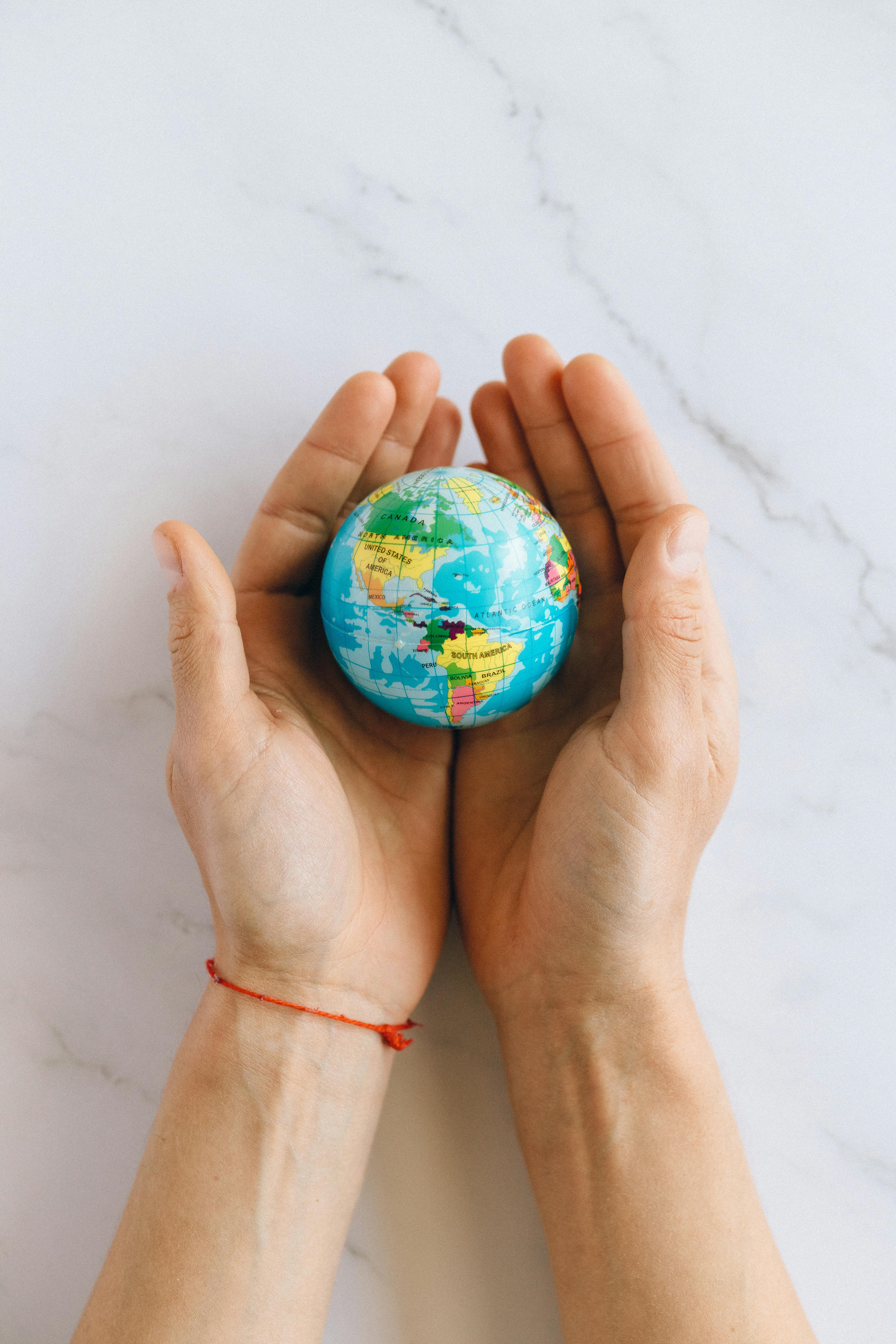 person holding a globe