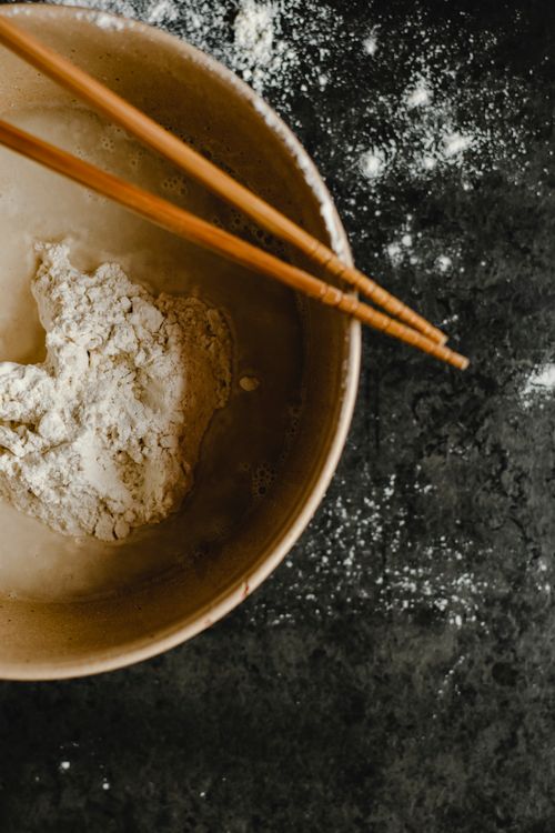 Free Top view of a bowl with chopsticks and flour, ideal for cooking themes. Stock Photo