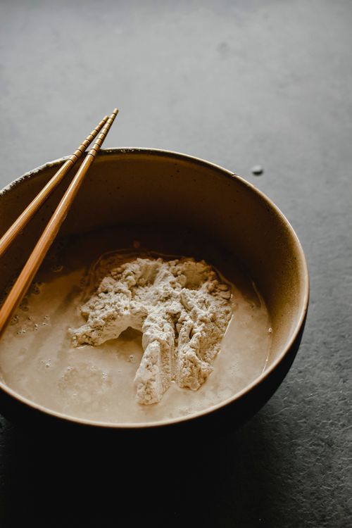 Free A close-up shot of flour and water mixture in a bowl with chopsticks. Stock Photo