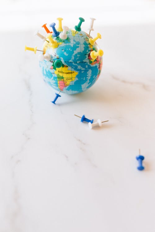 A Globe with Push Pins in Various Parts